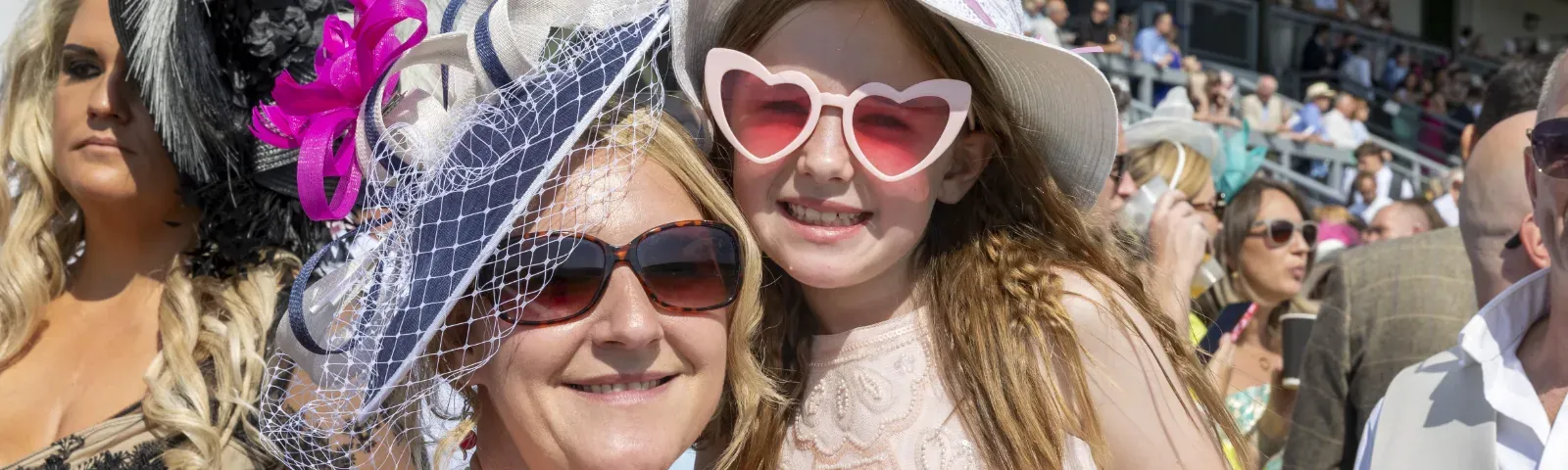 A mother and daughter in sunglasses pose for a picture at Ffos Las