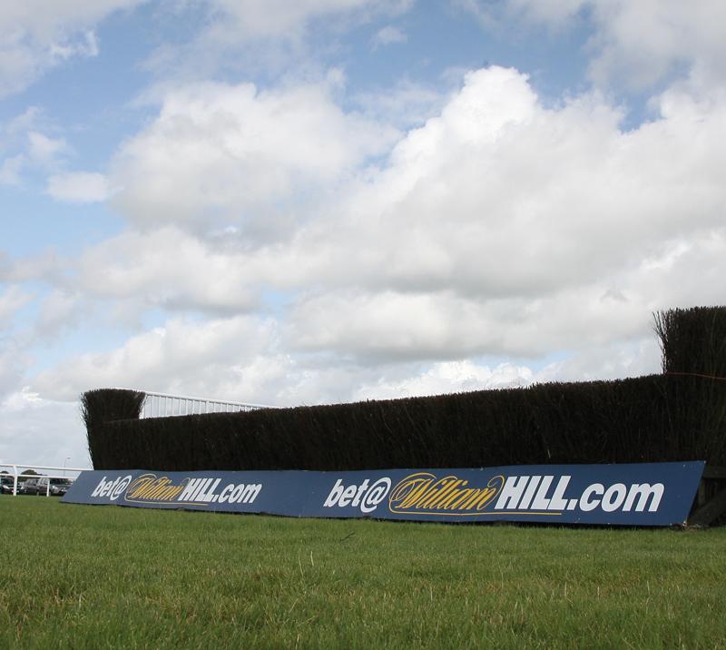 One of the hurdles at Ffos Las Racecourse with a hoarding attached to it.