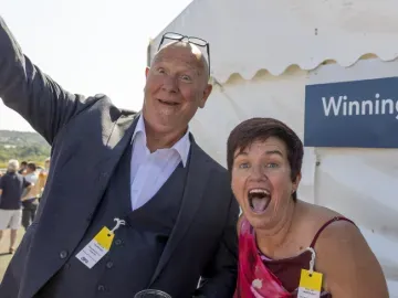 Two race goers at Ffos Las pull faces and smile for the camera