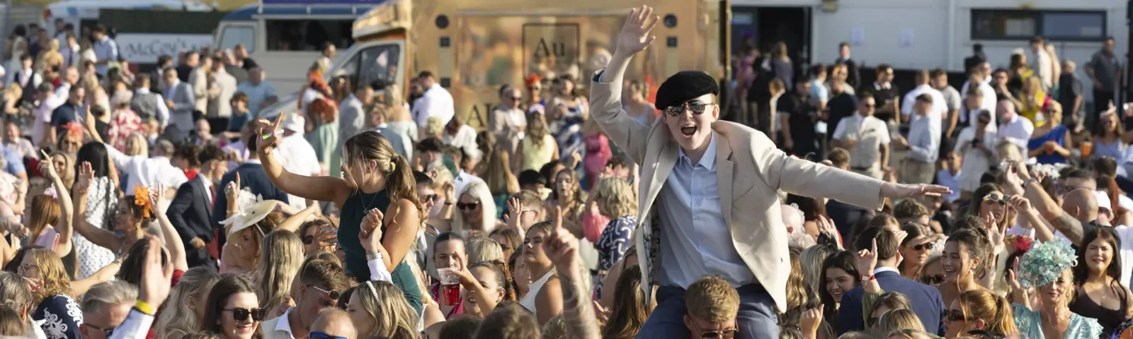 The crowd at Ffos Las with some guests on each others shoulders