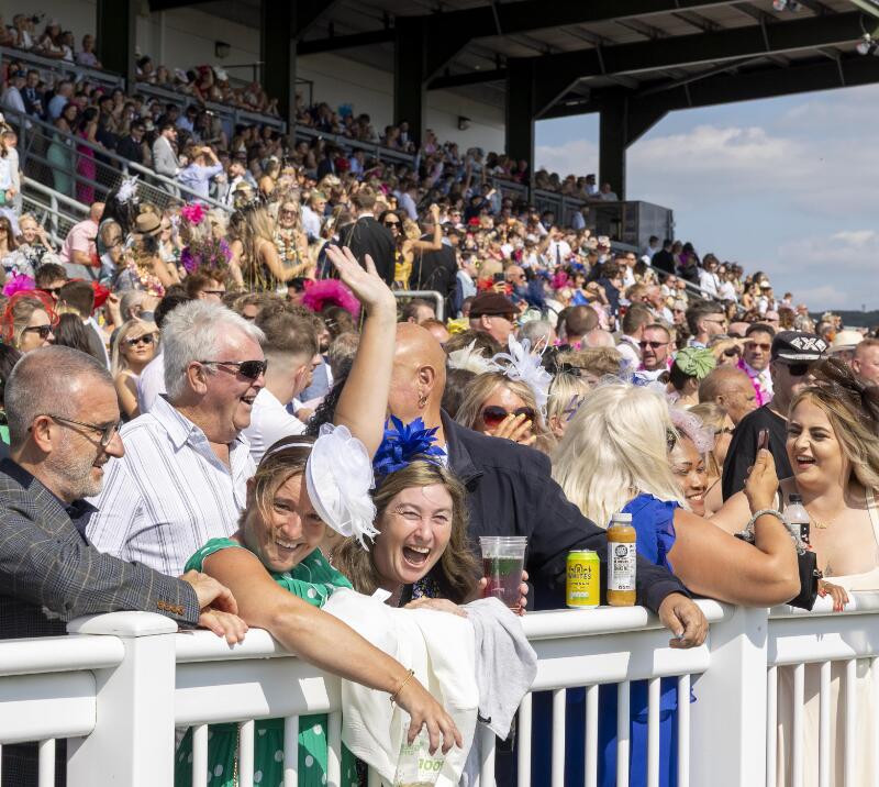 Race goers laugh and enjoy their day out at Ffos Las Racecourse