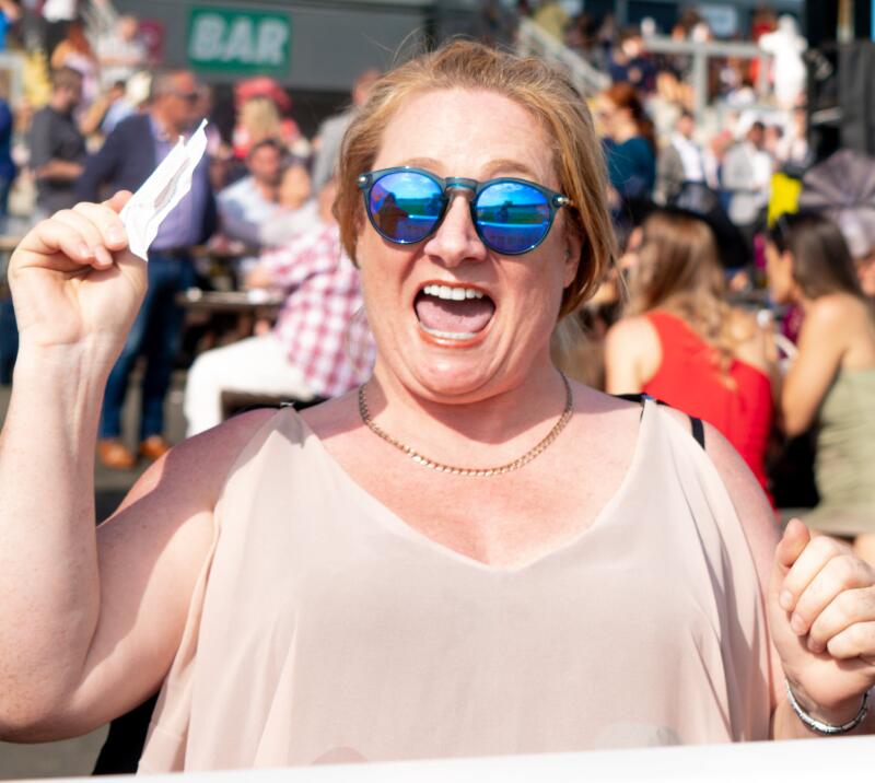 A race goer cheers with a betting slip at Ffos Las